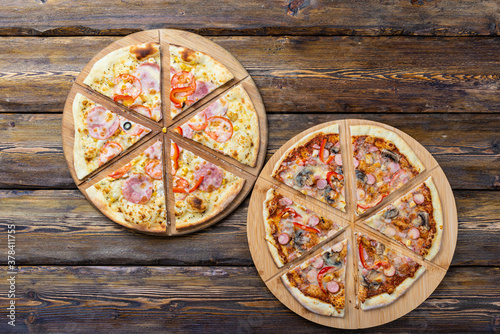 cutting board with hot testy pizza on wooden background,top view 