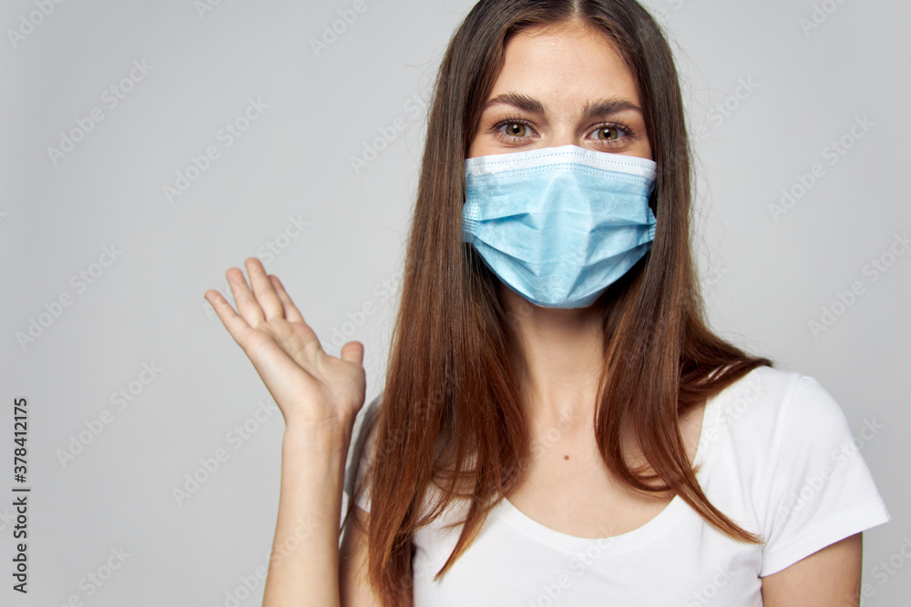 Woman in medical mask on face look forward Woman in medical mask on face look forward