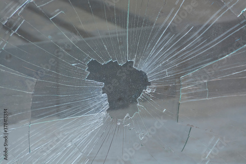 broken and shattered glass with many cracks and fragments