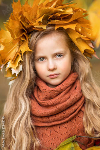 portrait of a beautiful girl child in autumn leaves