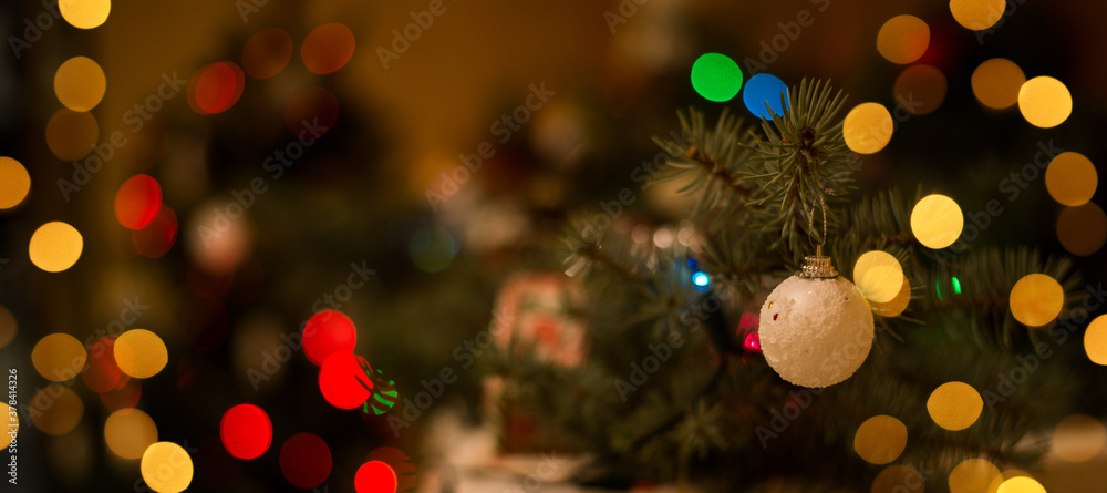 Bokeh. Christmas market out of focus. Blurred background of christmas trees, lights, illumination