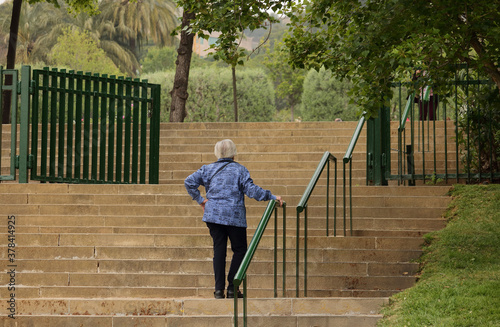 Bilde på lerret Old woman climbing stairs