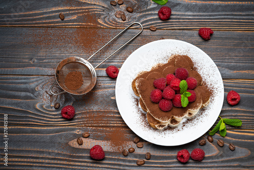Wallpaper Mural portion of Classic tiramisu dessert with raspberries on wooden background Torontodigital.ca