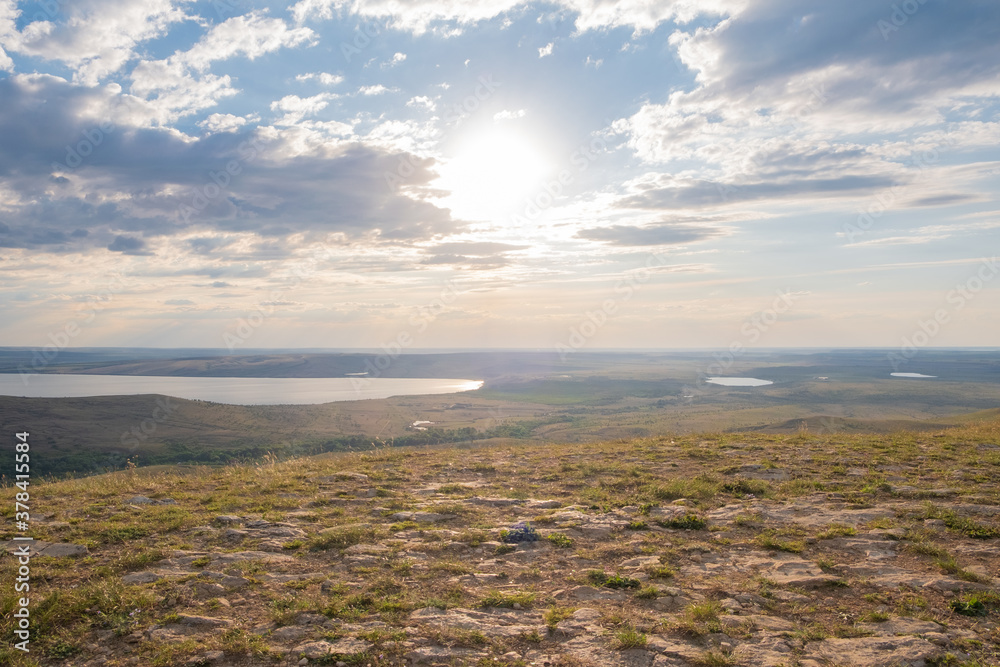 view of a lake and hills landscape at sunset. view of a lake and hills landscape at sunset.