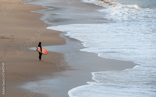 young surfer prepared to enter the water