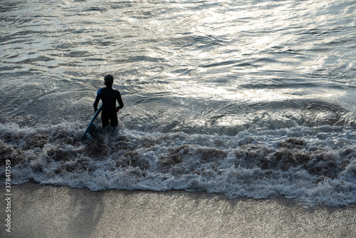 young surfer prepared to enter the water