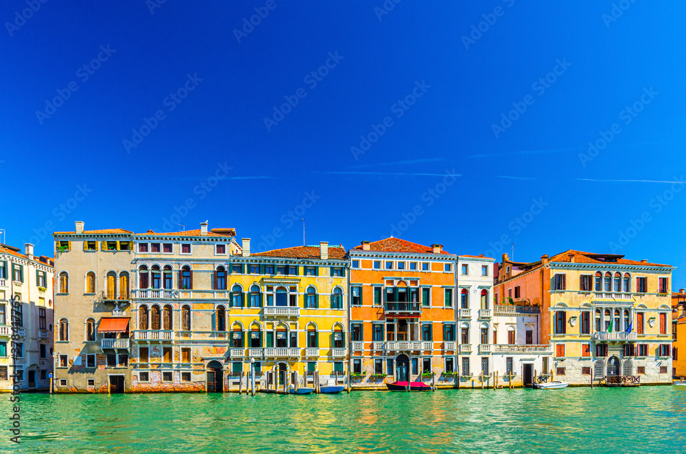 Grand Canal waterway with row of colorful multicolored palace buildings in Cannaregio sestiere Venice historical city centre, blue clear sky background copy space, summer day, Veneto Region, Italy