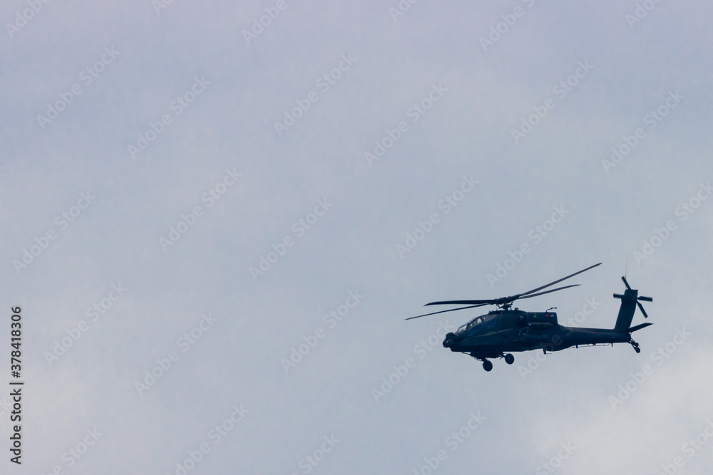 Silhouette of military helicopter flying in daylight Silhouette of military helicopter flying in daylight