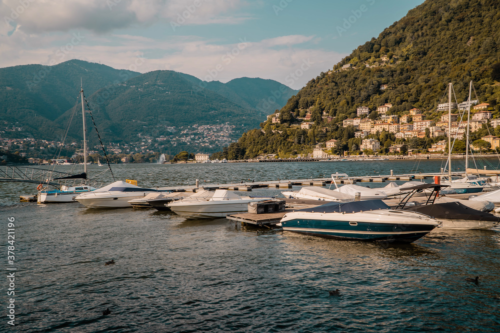 Sunset view of private motor and sailing boats on Lake Como, Lombardy, Italy