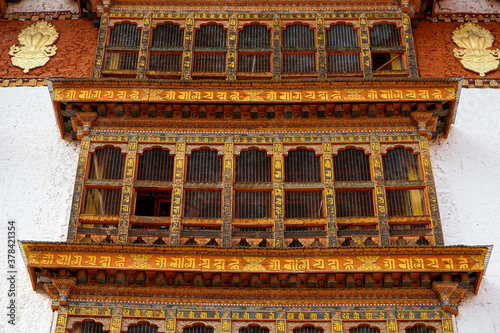 Bhutan,  Paro, October: wooden windows in the oldest temple of Bhutan, the Kyichu Lhakhang. 
