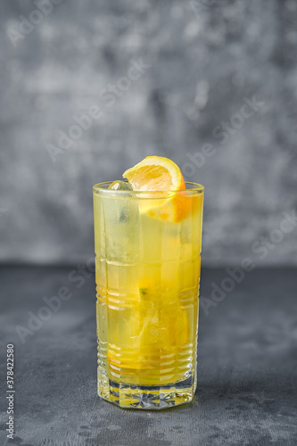 Cocktail with rum and orange juice on gray background