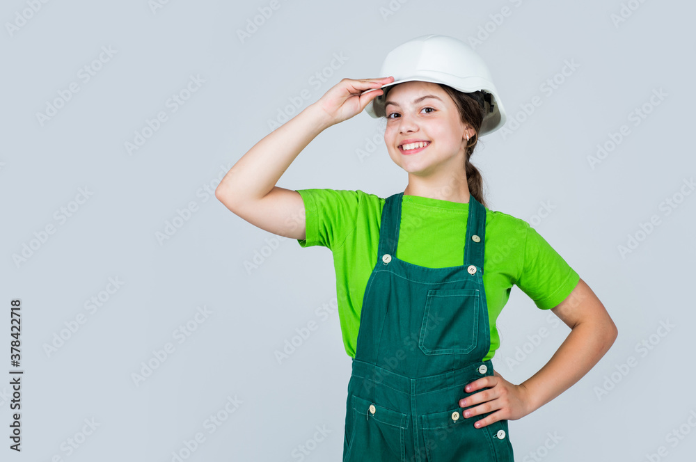 Little girl engineer. Visiting Construction Site. childhood and education concept. baby building. cute kid putting on construction helmet. childhood happiness concept