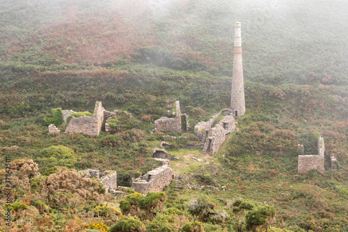 Old tin mine in thick fog photo