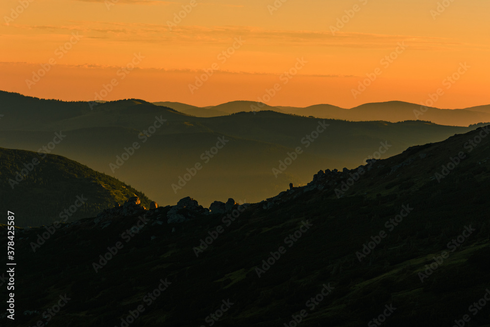 Fog or haze at sunrise in the Carpathians, Ukrainian Pip Ivan and sunrise near Montenegro, picturesque mountain landscapes.