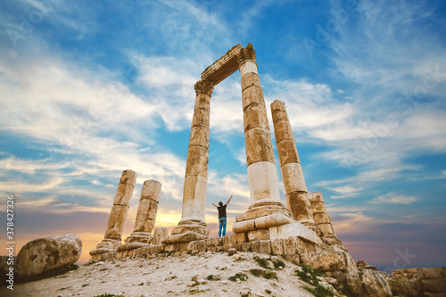 the citadel in the city of Amman in Jordan in the middle east at the sunset. Temple of Hercules of the Amman Citadel (Jabal al-Qal'a) with a young man