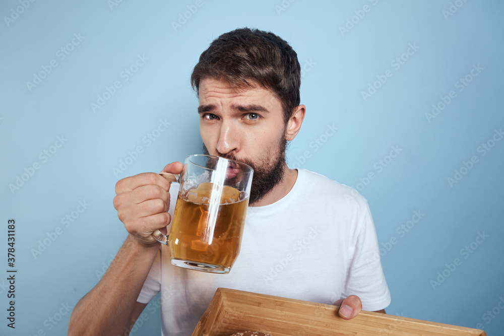 Cheerful man mug of beer fast food diet food lifestyle blue background alcohol Cheerful man mug of beer fast food diet food lifestyle blue background alcohol