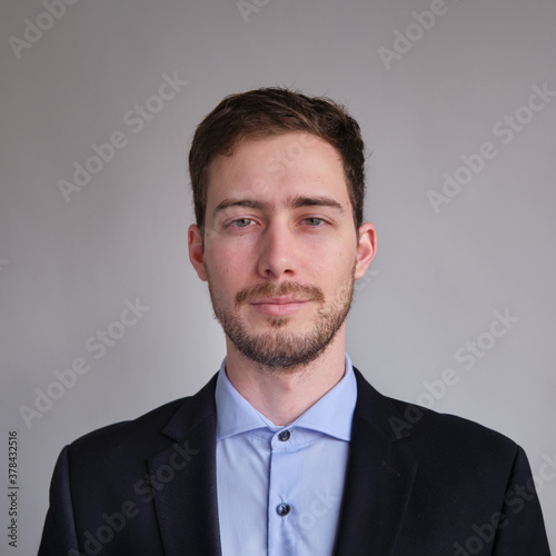 passport photo of cute and well dressed Caucasian man in jacket shirt or suit and tie