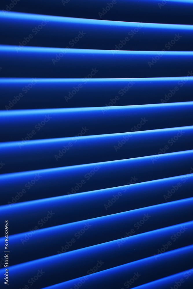 Obraz premium Blue shutter blinds in a sunny day
