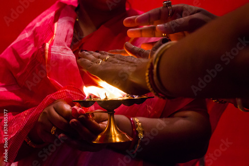 Obraz na plátně hands taking flame heat, a ritual of blessings in hindu god worship
