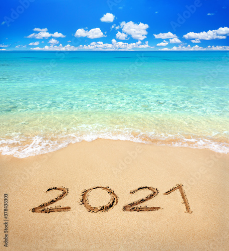 2021 written on sandy beach