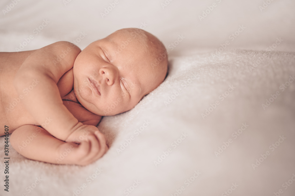 Cute emotional newborn funny little baby boy sleeping in crib. Baby goods packaging template. Healthy child, concept of hospital and happy motherhood. Infant baby. Nursery Cute emotional newborn funny little baby boy sleeping in crib. Baby goods packaging template. Healthy child, concept of hospital and happy motherhood. Infant baby. Nursery