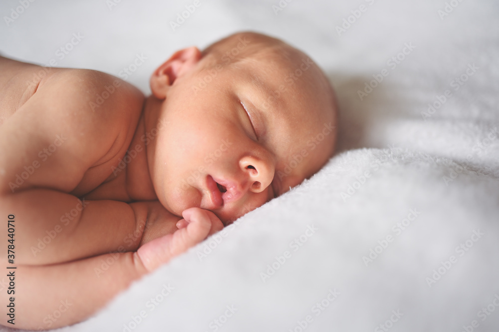 Cute emotional newborn funny little baby boy sleeping in crib. Baby goods packaging template. Healthy child, concept of hospital and happy motherhood. Infant baby. Nursery Cute emotional newborn funny little baby boy sleeping in crib. Baby goods packaging template. Healthy child, concept of hospital and happy motherhood. Infant baby. Nursery
