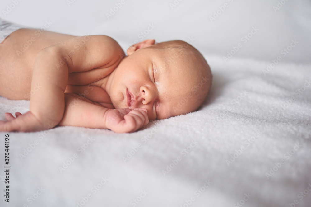 Cute emotional newborn funny little baby boy sleeping in crib. Baby goods packaging template. Healthy child, concept of hospital and happy motherhood. Infant baby. Nursery Cute emotional newborn funny little baby boy sleeping in crib. Baby goods packaging template. Healthy child, concept of hospital and happy motherhood. Infant baby. Nursery