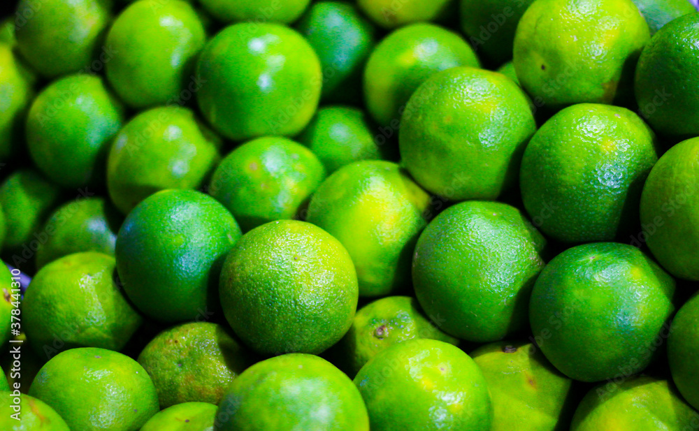 heap of green sweet lime for sale in market heap of green sweet lime for sale in market