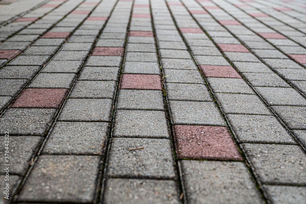 Perspective view of red and gray rectangular stones paved texture background.