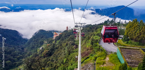 cable car at genting highlands, malaysia in a foggy weather with green grass visible from inside cable car