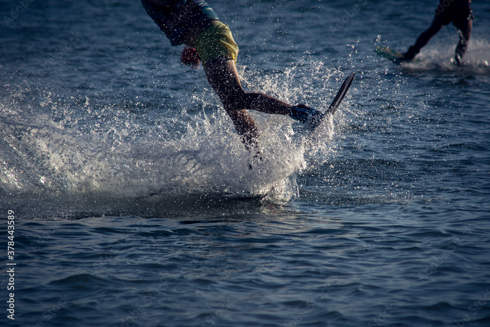 Fototapeta premium WAKEBOARDING AT THE SEA LANDING FROM A JUMP. CONCEPT OF EXTREME SPORTS IN WATER