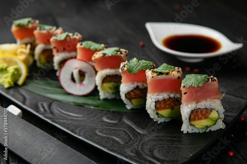 Japanese rolls with salmon, tuna on a wooden table 