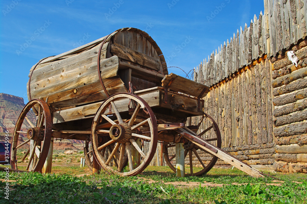 Vintage Wooden Water Wagon outside a wooden stockade