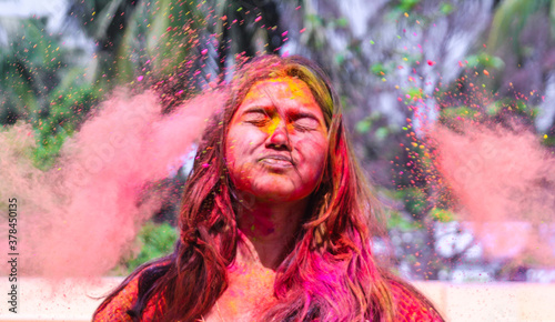 Photography a lady getting showered with holi colours during holi festival in india