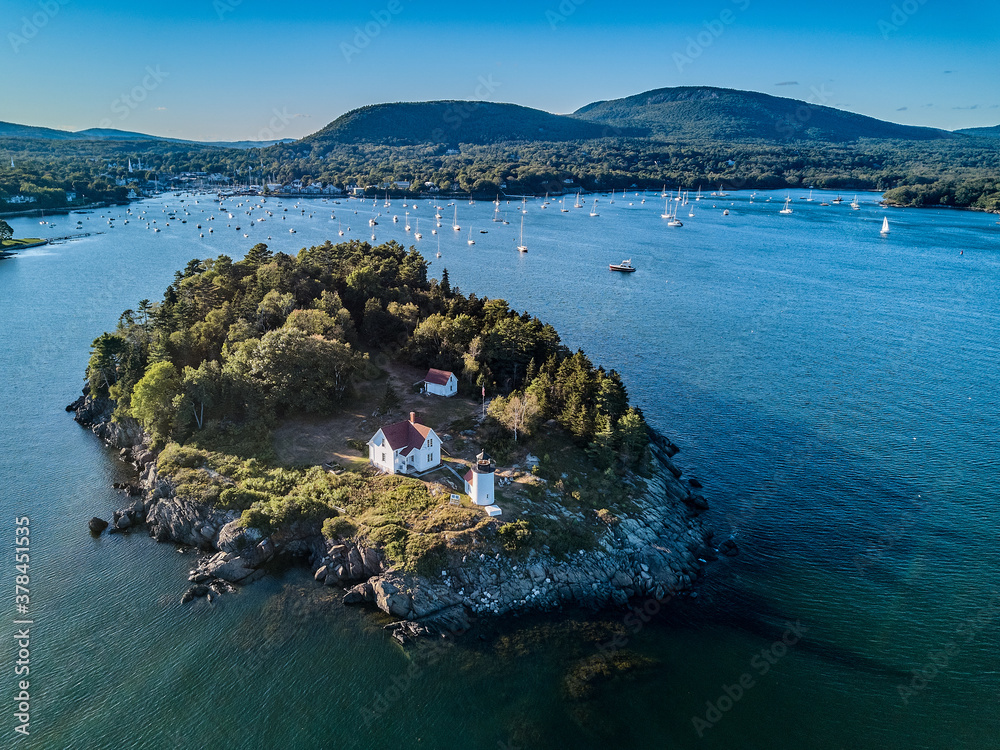 Obraz premium Aerial Drone image of the Curtis Island Lighthouse att he entrance to Camden Harbor on Penobscot Bay in Maine on a late afternoon