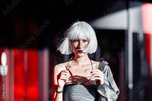 Blonde on a red background with stylish clothes. cyberpunk style 
