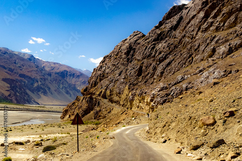 curved hilly highway in between barren himalayan mountains of leh ladakh, jammu and kashmir, India