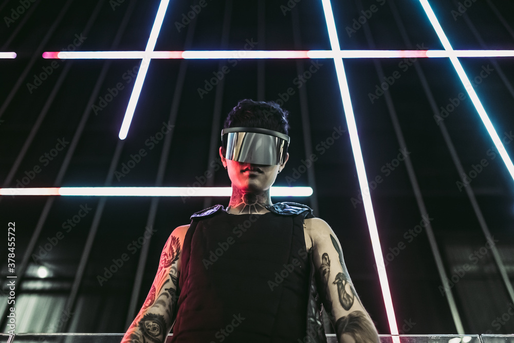Man in futuristic glasses in a neon night city. Man in futuristic glasses in a neon night city.