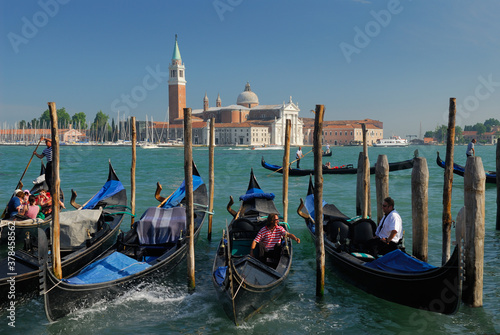 Gondoliers working the Giudecca Canal in front of San Giorgio Maggiore in Venice