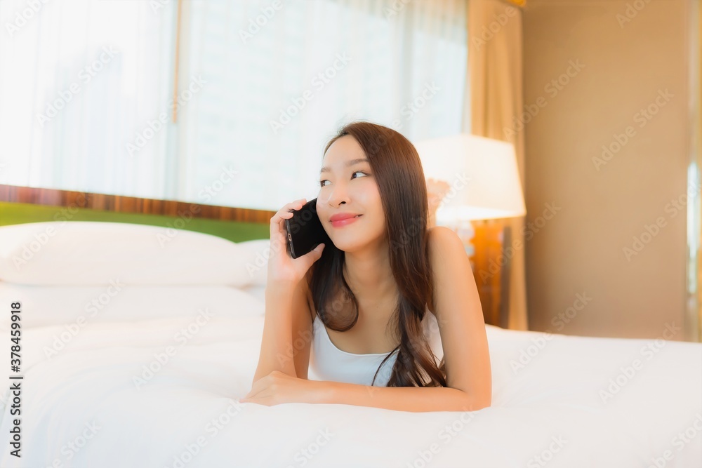 Portrait beautiful young asian woman use smart mobile phone on bed Portrait beautiful young asian woman use smart mobile phone on bed