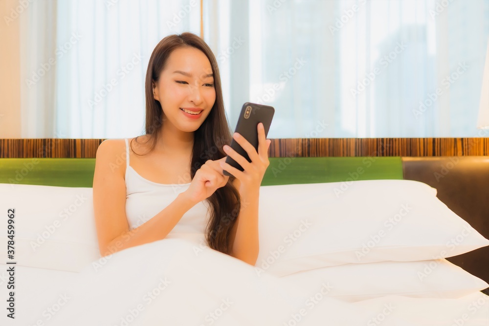 Portrait beautiful young asian woman use smart mobile phone on bed Portrait beautiful young asian woman use smart mobile phone on bed