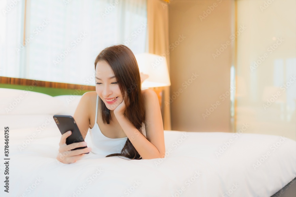 Portrait beautiful young asian woman use smart mobile phone on bed Portrait beautiful young asian woman use smart mobile phone on bed