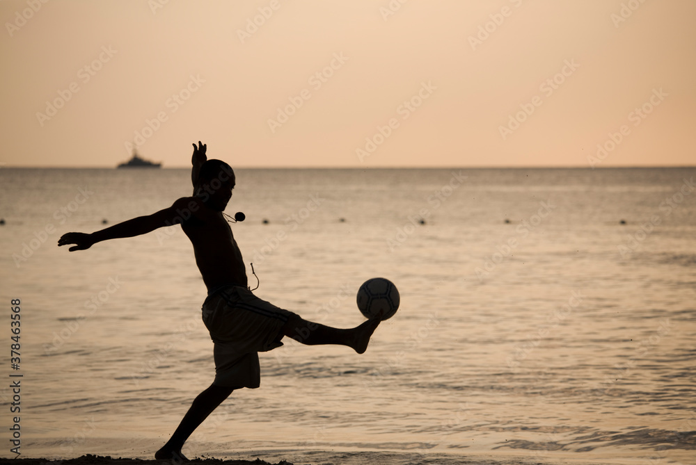 Man Playing Soccer on Beach, Negril, Jamaica