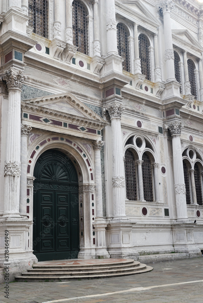 Front door and white marble facade of San Rocco in Venice