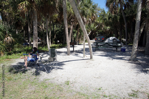 Young girl enjoying tent camping environment n Fort De Soto Park in Pinellas County, Florida. photo