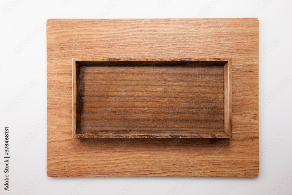 A square wood tray isolated white, top view at the studio. A square wood tray isolated white, top view at the studio.