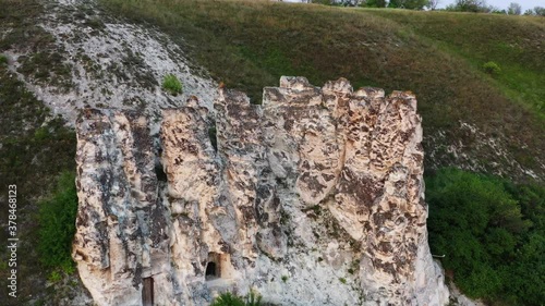 Aerial around view of temple in a white chalk rock in Divnogorye at sunset, Russia, 4k photo