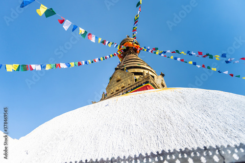 Tower of the Boudhanath Stupa decorated with flags in Kathmandu, Nepal. photo