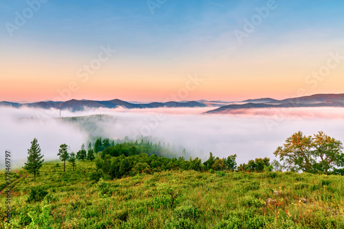 The morning fog between the mountains landscape.