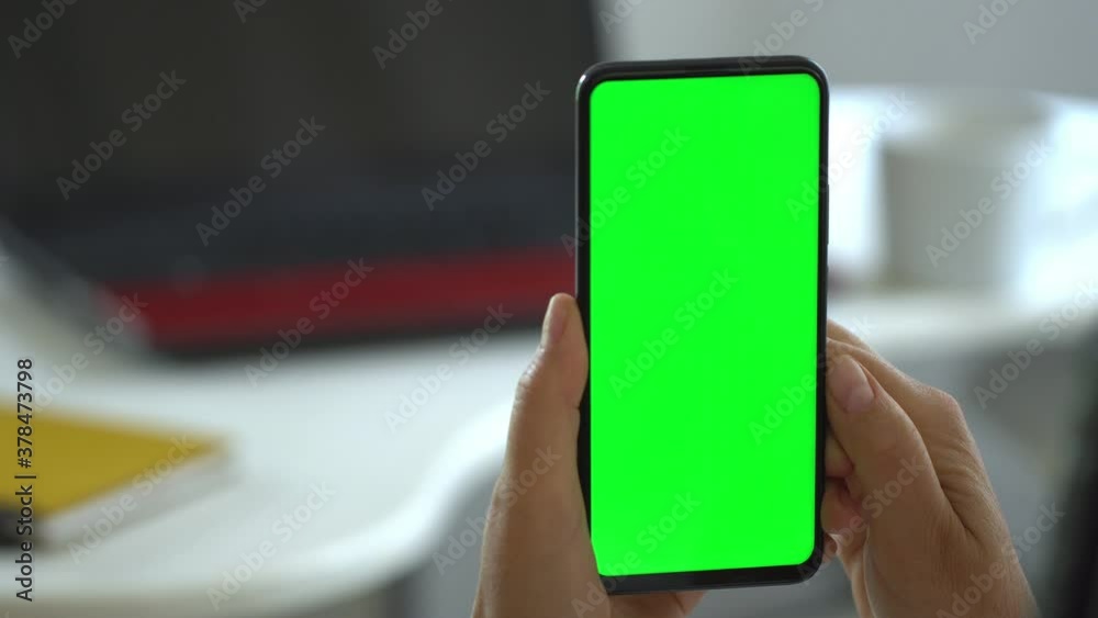 Handheld Camera: Point of View of Woman at Modern Room Sitting on a Chair Using Phone With Green Mock-up Screen Chroma Key Surfing Internet Watching Content Videos Blogs Tapping on Center Screen
